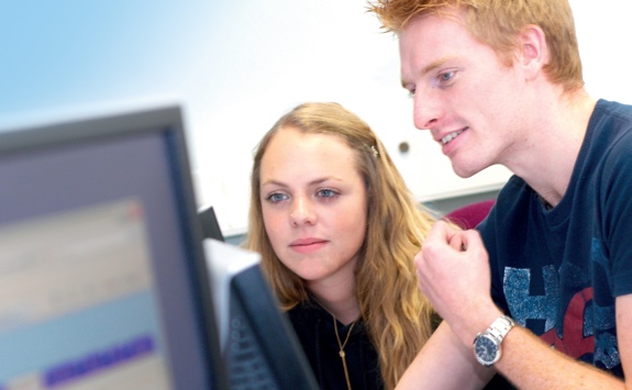 Students looking at a laptop